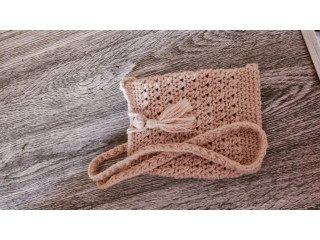 Homemade crochet tan side bag with tassel opening for phone or waterbottle